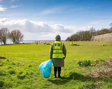 Litter picking on an open field